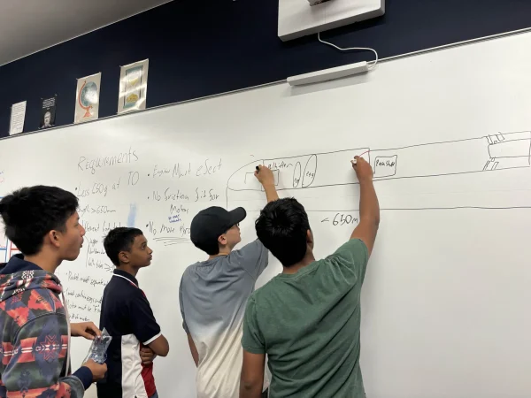 Members of the Aviation Club working on the design of the rocket during a meeting.