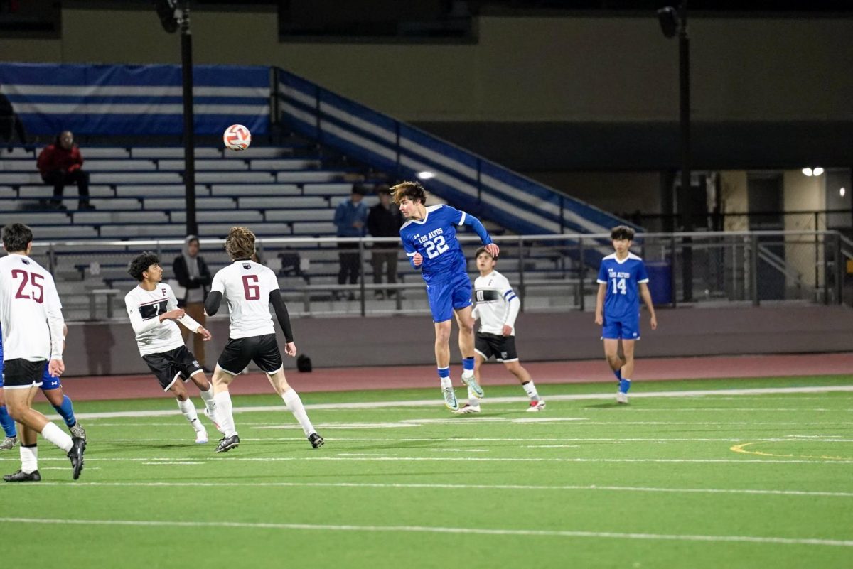 Senior Connor Salita jumps in the air for a header, looking to pass to an Eagle teammate upfield. 