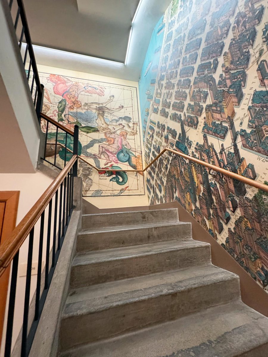 A three-flight stairwell—with maps imprinted on all sides of the walls—leads viewers up to the center.