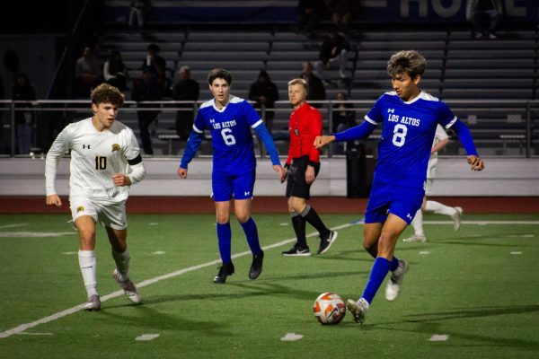 Sophomore Walter Guzman dribbles past a Spartan defender and attempts to push further into Spartan territory. 