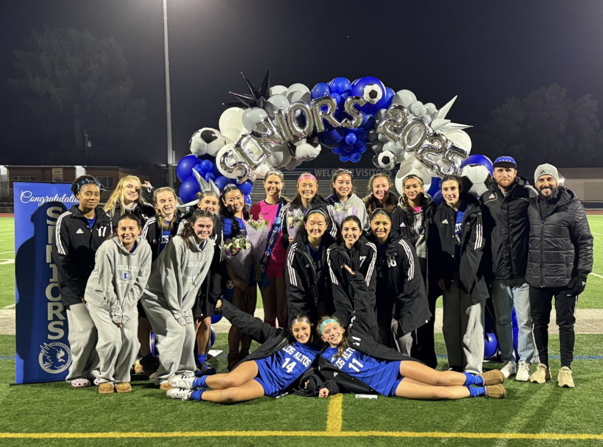  The varsity girls soccer team poses for a picture on senior night while celebrating the class of 2025 with gifts and flowers. 
