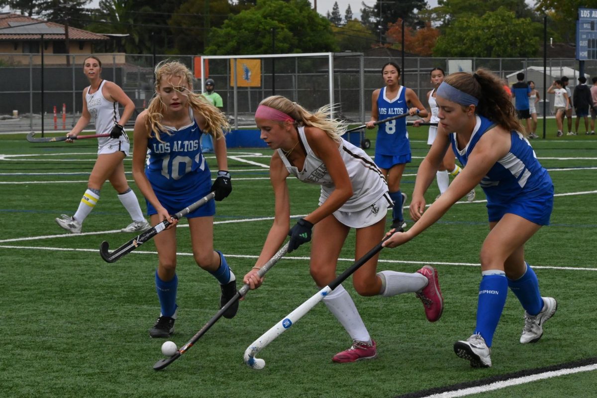 Two Los Altos players battle to steal the ball back from the Saint Francis Lancers. 