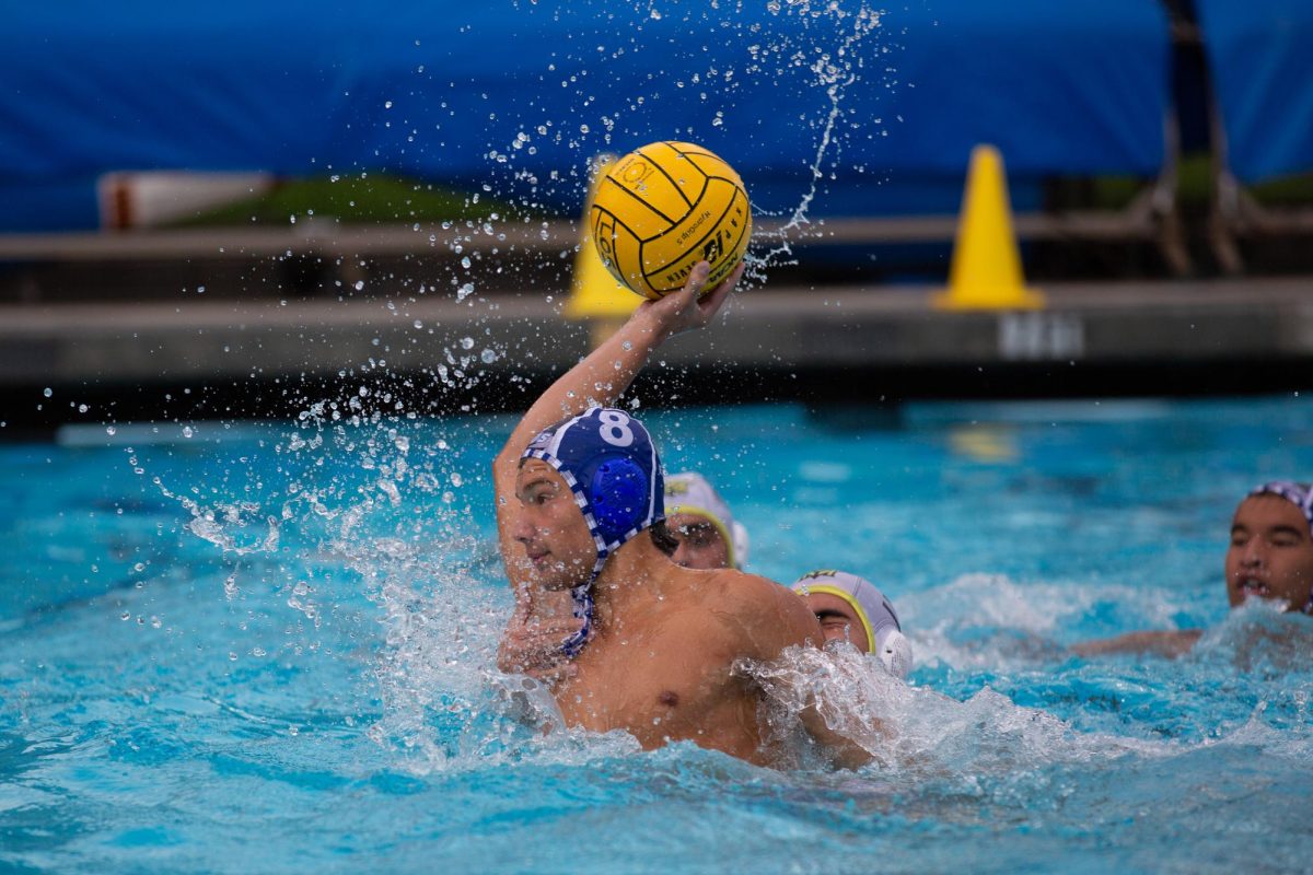  Junior David Feldman dodges a Mountain View water polo player during the season’s first rivalry game Sep. 18. The varsity boys water polo team won 17–5, and the varsity girls won their game 16–2 that same night.