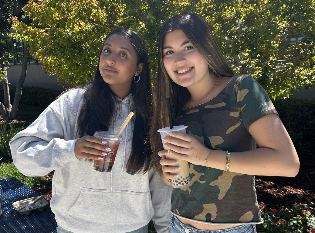 Talon senior writer junior Manya Sikka and staff writer junior Jade Palatnik hold their boba drinks and smile for the camera. In this edition of “The Winner Is,” staff writer junior Kate Rose, Manya and Jade tried and rated boba drinks from different stores. 