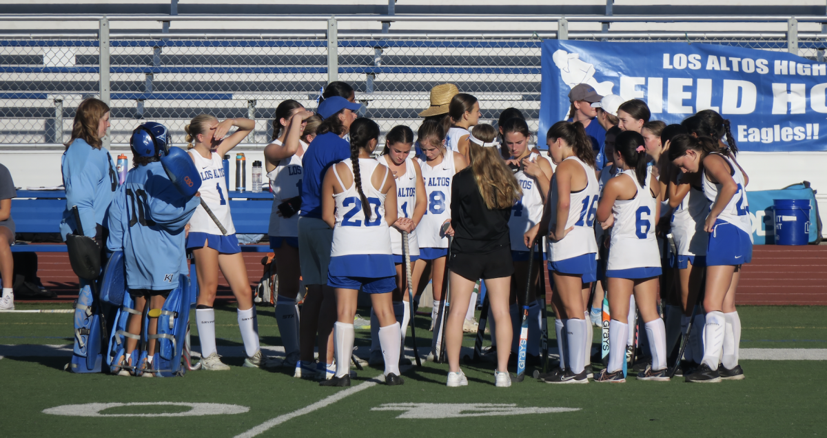 Varsity girls field hockey huddles before a game last fall. The team plans to improve this year through athletic success and team community. 