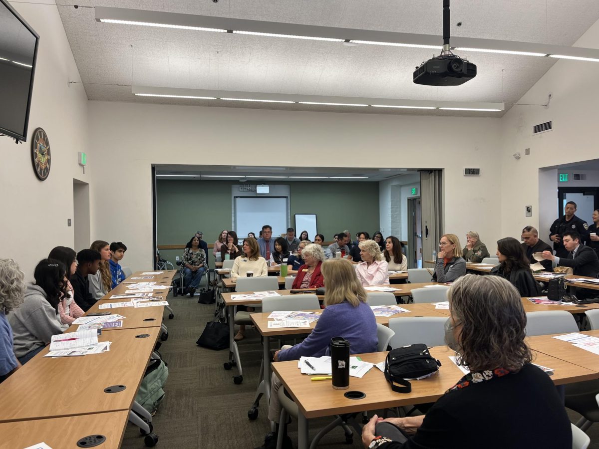 Members of the Challenge Team (PAC), a local student organization, listen to members of PAC answer questions at their meeting on Oct. 9 at the Mountain View Police Station. This marked the first time PAC was able to express student needs to the community.