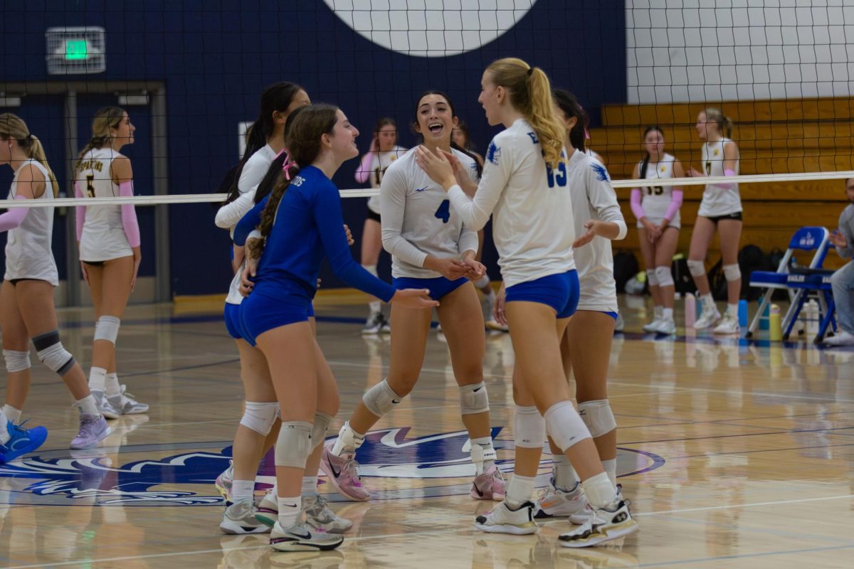 The varsity girls volleyball team celebrates their senior night win against Mountain View on Thursday, Oct 16, after presenting the seniors with speeches and flowers. 