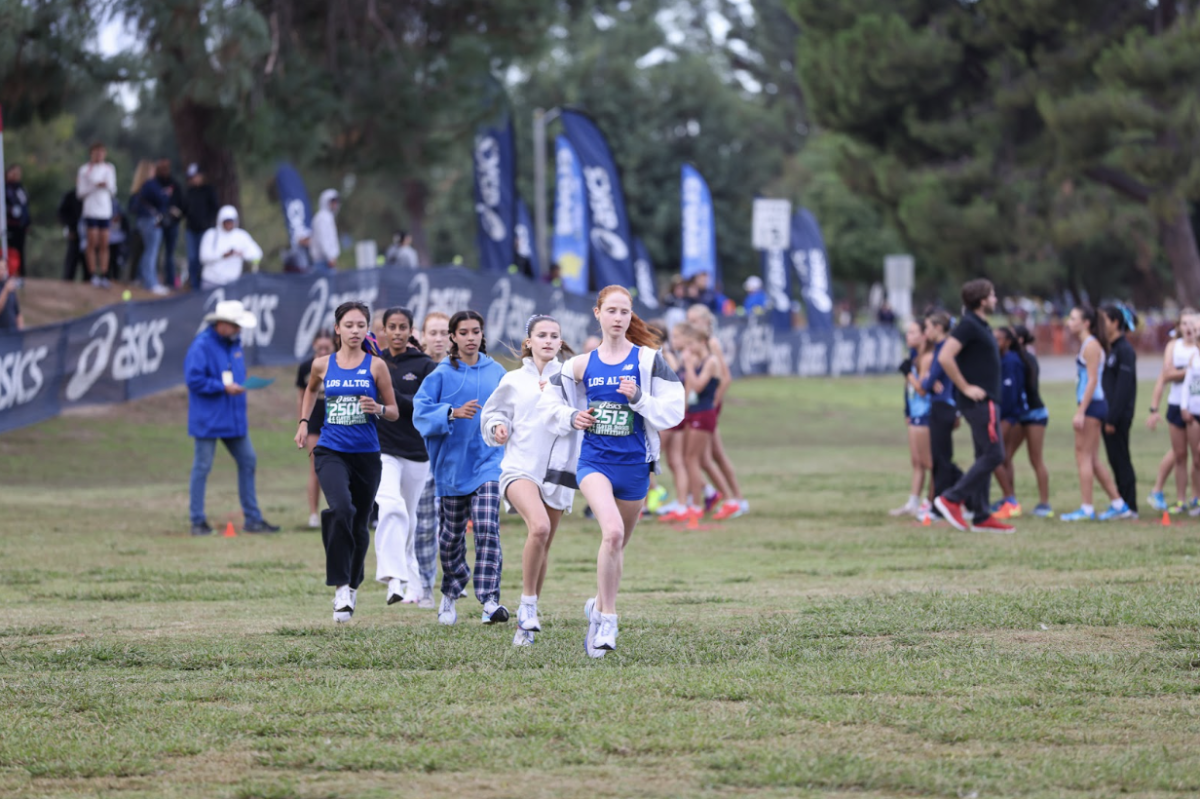 Los Altos High School girls cross country jogs to the starting line as they are announced for the Championship Race at the Clovis Invitational on October 11. The team placed 11th overall and 10th in the state of California. 
