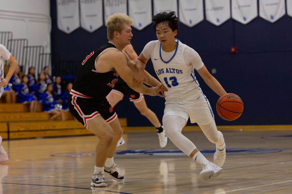 Rian Mao dribbles the ball down the court and passes the Los Gatos defender as he heads towards the net. The boys' basketball team finished last season with a 1-11 record in the league.