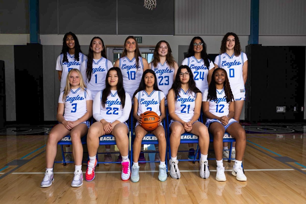 The LAHS varsity girls basketball team poses for their team photo. The team has experienced significant changes in the roster this season, most notably adding three new freshmen in a rare occurrence.