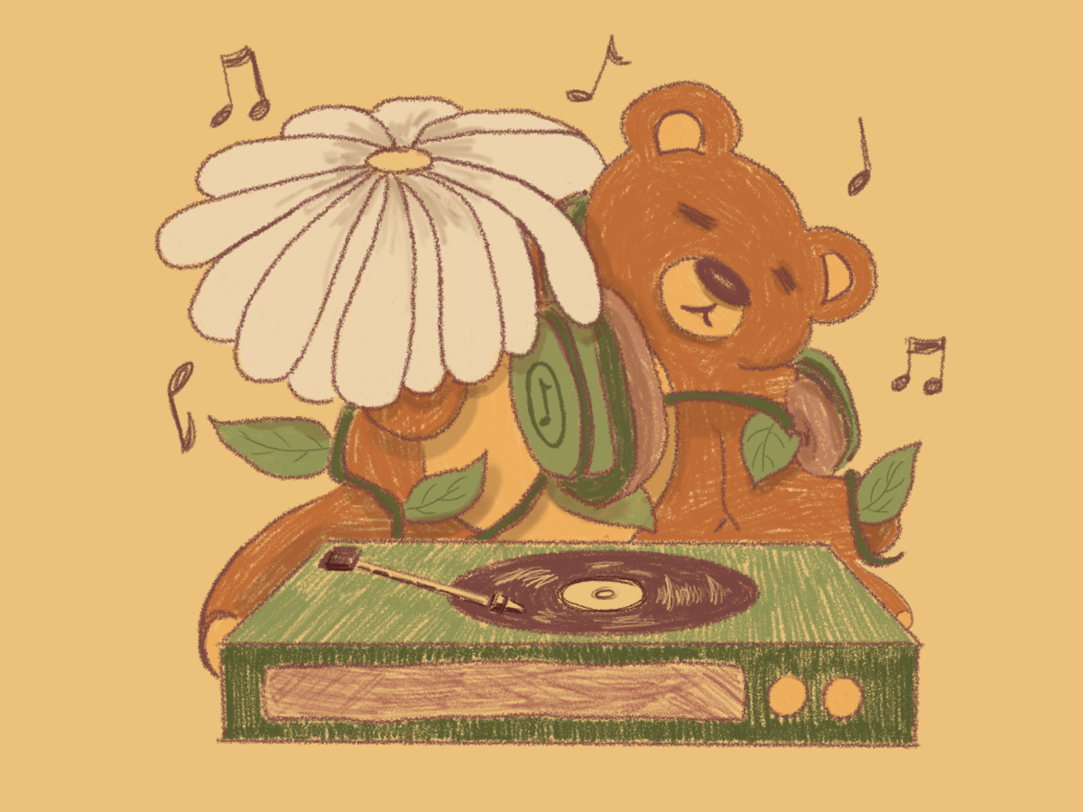 Headphones on a teddy bear with music playing in the background coming from a record player. The image shows the types of media I use to listen to music. 