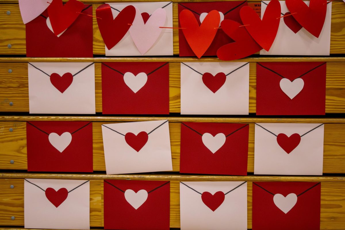 Red and pink paper envelopes adorn the Large Gym as festive Valentine's Day decorations for ASB's annual faire.