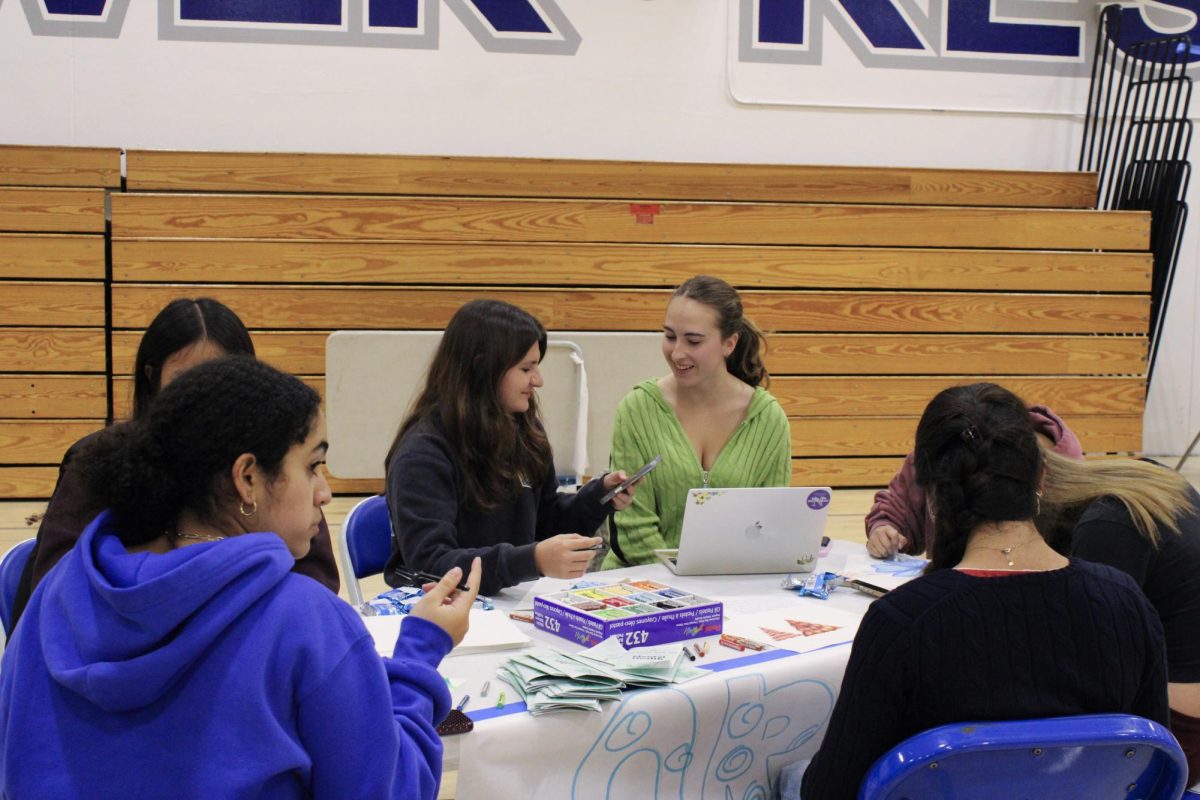Seniors Ari Yurchenko and Matilda Haney Foulds chat and doodle at Art Club’s coloring station. SCL’s Break the Stigma event aimed to raise awareness to teenage mental health and well being.