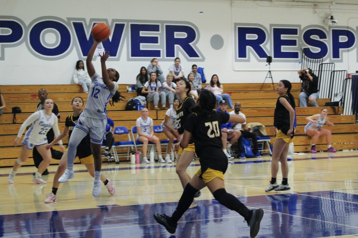 Freshman Taylor Ware shoots a basket at the Eagles’ Jan. 30 rivalry rematch. After beating the Spartans by only 2 points in their first matchup, the Eagles dominated the competition in round two. 