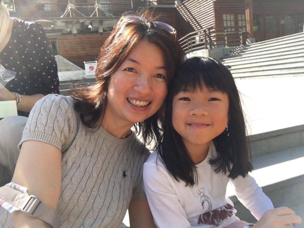 On the steps of a nature reserve, I sit beside Cynthia, my mother. I’d argue that she looks the same, while I’ve definitely grown out of my straight-bangs-awkward-phase. 