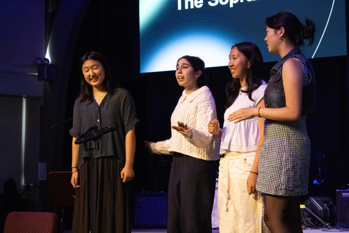 Senior Mira gestures as she sings.