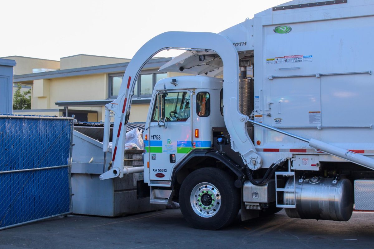A garbage truck from Recology South Bay empties an LAHS dumpster. The combined trash/recycling dumpsters are emptied daily.