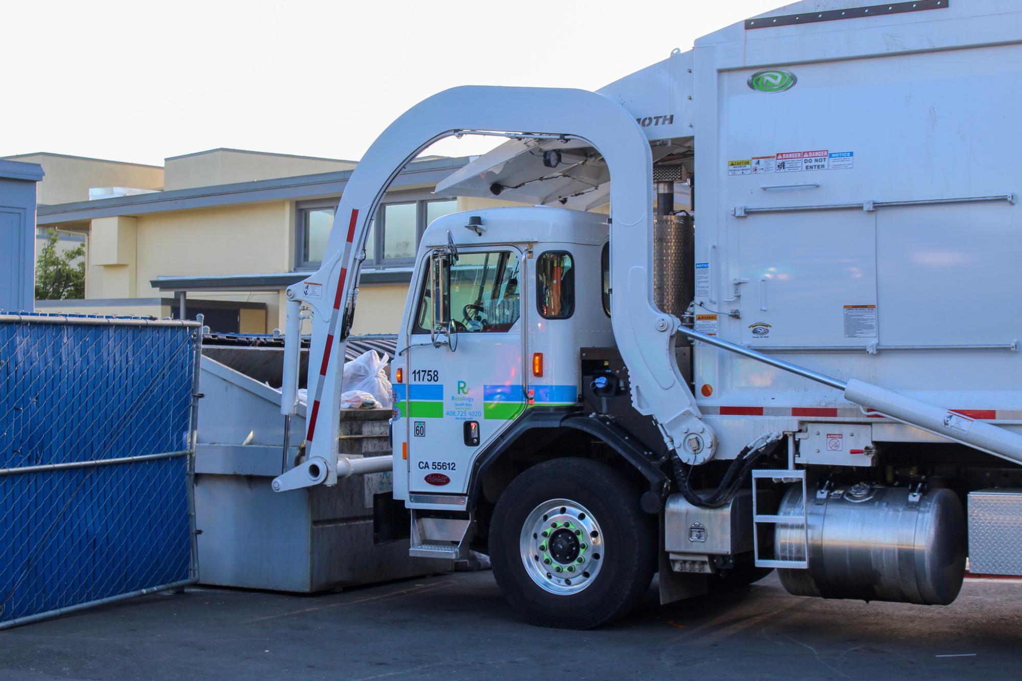 A garbage truck from Recology South Bay empties an LAHS dumpster. The combined trash/recycling dumpsters are emptied daily.