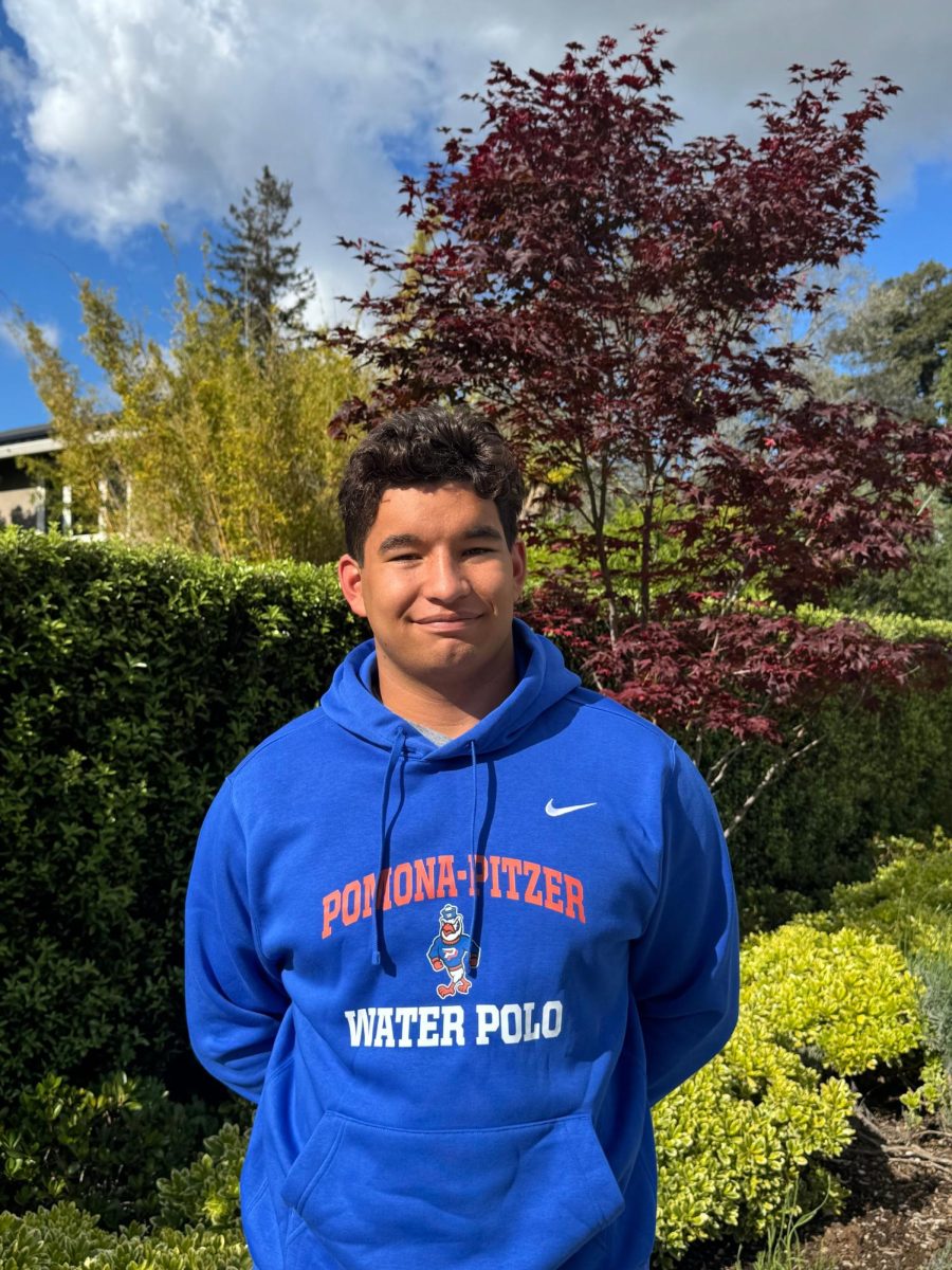 Tiernan, crucial defense leader on the LAHS water polo team, shows off his Pitzer College merchandise. He will join the school's DIII water polo team in the fall, chosen for its emphasis on team community and athletic achievement.
