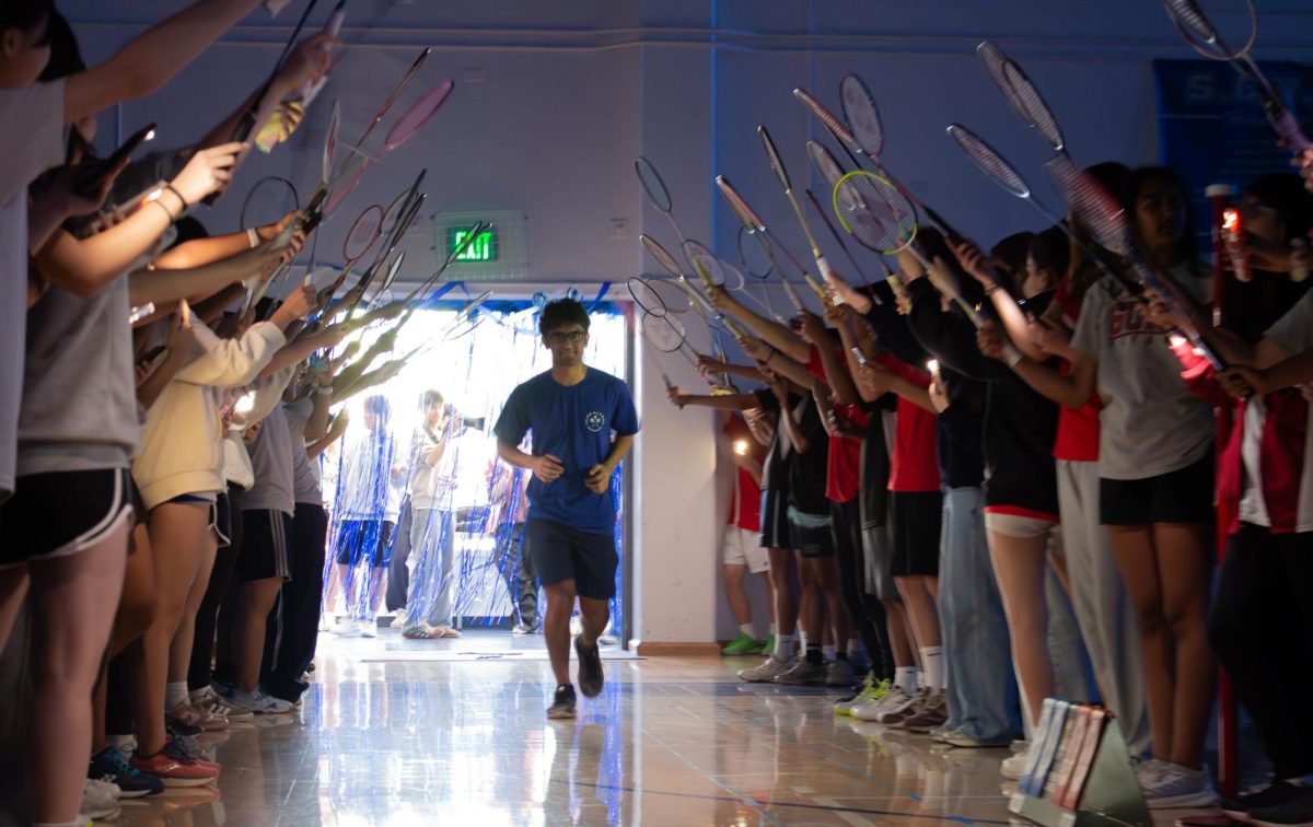 Senior Aditya Rajesh runs through a tunnel made of rackets, formed by both the Eagles and the Gunn Titans, to celebrate senior night. Los Altos fell 6–24 that night to Gunn.
